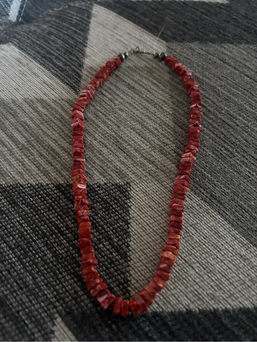 Native made red spiny oyster necklace.